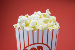 Classic box cinema popcorn on red background